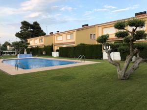 a swimming pool in a yard next to a house at Casa Ocean by MarCalma in Montroig