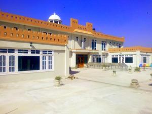 a large white building with a domed roof at Stargaze Hotel & Apartment in Abbottabad