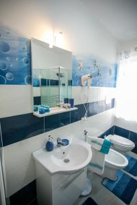a bathroom with a sink and a toilet and a mirror at La casa del pescatore in Oliveri +37 photos