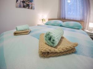 a bedroom with a bed with two towels on it at KUĆA ZA ODMOR NATALIJA in Pula