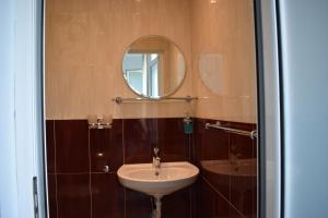 a bathroom with a sink and a mirror at Синя луна in Lozenets +45 photos