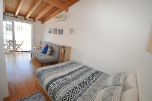 a bedroom with a bed and a couch at Casa Azul in Barão de São João