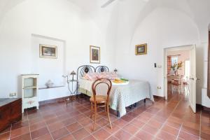 a bedroom with a bed and a table and chairs at Casa Nelly in Gallipoli +33 photos