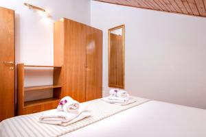 Postel nebo postele na pokoji v ubytování Apartmani Nivia