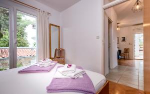 Postel nebo postele na pokoji v ubytování Apartmani Nivia
