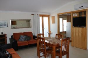 a living room with a table and a couch at Grace Beach House in Nazaré