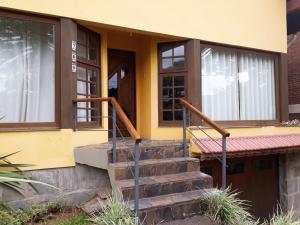 a house with a staircase leading to the front door at El Refugio 700 in Gramado