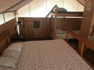 a bedroom with a bed and a bunk bed at Sven's Basecamp Hostel in Fairbanks