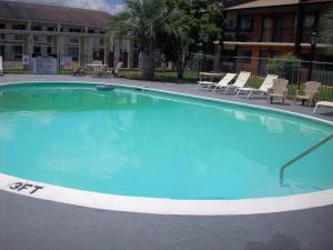 a large swimming pool in front of a building at Days Inn by Wyndham Dothan in Dothan