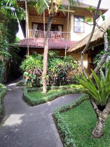 a resort with a walkway in front of a building at Ubud Lestari Bungalows in Ubud