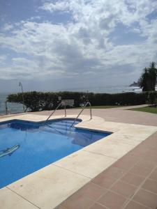 a swimming pool with a view of the ocean at Edificio Rosa de los Vientos apartamento 71 in Mijas