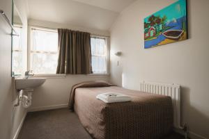 Cama ou camas em um quarto em Kiwi International Hotel