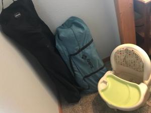 a blue backpack sitting next to a baby crib at Gonzales Cozy Little Bear Cabin in Ruidoso +45 photos