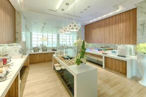 a large kitchen with wooden cabinets and white counters at Six Star Motel-Taoyuan in Taoyuan