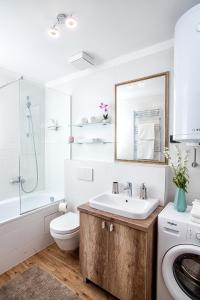 a bathroom with a sink and a toilet and a mirror at A Blok-Apartment The One in Belgrade