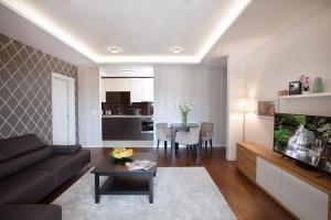 a living room with a couch and a dining room at A Blok-Apartment The One in Belgrade