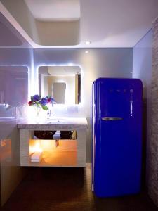 
a white refrigerator sitting in a kitchen next to a sink at inhouse Hotel in Taipei
