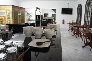 a table with plates and cups on top of it at Heeren Palm Suites in Melaka