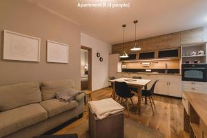 a living room and kitchen with a couch and a table at Luxury Chalet Mallnitz in Mallnitz