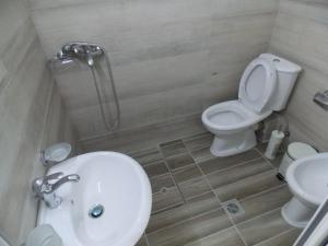 a bathroom with a toilet and a sink at Vila Gjoni in Sarandë +36 photos