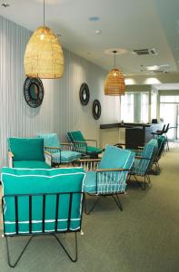 a waiting room with blue chairs and tables at Best Western Plus Hôtel La Joliette in Marseille +113 photos