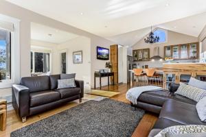 a living room with a couch and a table at Topiary Haven in Launceston
