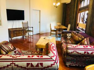 a living room with two couches and a table at Aura Hotel in Wellington