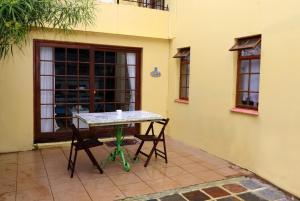 a table and chairs on a patio outside a building at Tuksumduin in Ballito