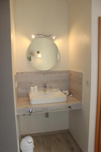 a bathroom with a sink and a mirror at Auszeit am Eifelsteig in Daun +62 photos