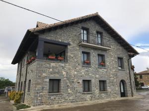 a brick building with windows and a balcony at Casa Campo in Abay