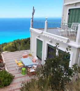 a view of the ocean from the balcony of a house at Porto Katsiki Blu in Athani