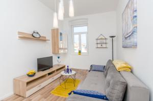 a living room with a couch and a tv at City Core Apartment in Split