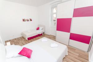 Postel nebo postele na pokoji v ubytování City Core Apartment