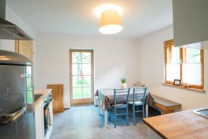 a kitchen with a table and chairs in a room at Pr' Kovač apartments in Bohinjska Bela