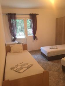 Postel nebo postele na pokoji v ubytování DK Apartmani