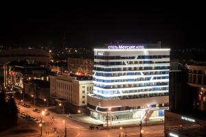 a lit up building in a city at night at Mercure Saransk Center in Saransk