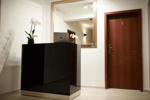 a black television in a room with a door at Villa Agawa in Niechorze