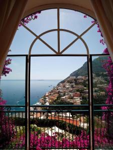 a view of the ocean from a window at Villa dei Fisici Positano in Positano