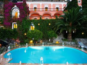 a large swimming pool in front of a building at Villa dei Fisici Positano in Positano