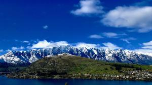a view of a mountain with a town and a city at Remarkable Lake House in Queenstown +52 photos