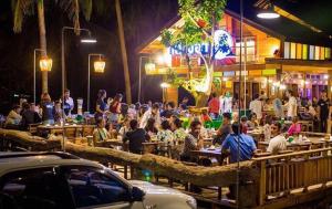 a group of people sitting at tables in a restaurant at Klang Aow Seafood & Resort in Khanom