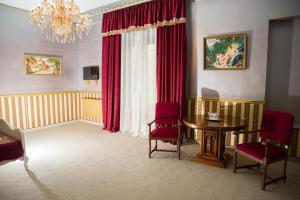a room with a table and chairs and a chandelier at NF Palace Old City Bucharest in Bucharest