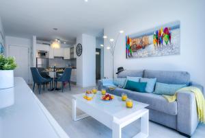 a living room with a couch and a table at Modern Apartment Los Cristianos Center in Los Cristianos
