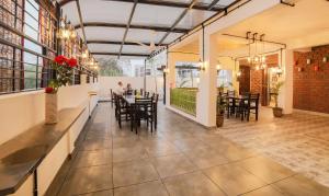 a restaurant with tables and chairs in a room at Treebo Trend Chalets, Nagpur Airport in Nagpur