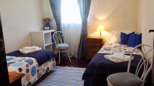 a small bedroom with two beds and a window at Casa das Lages in Paredes de Coura