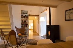 a living room with a table and chairs at La Colline des Renards Chambres in Locmaria-Berrien