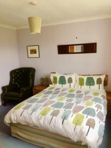 a bedroom with a bed and a chair at The Lovecroft Guest House in Laide +19 photos