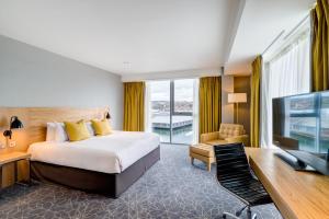 
a hotel room with a bed and a television at Apex City Quay Hotel & Spa in Dundee
