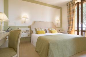 Postel nebo postele na pokoji v ubytování Relais Santa Chiara Hotel - Tuscany Charme