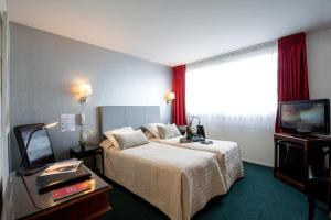 מיטה או מיטות בחדר ב-Bristol Logis Cit'Hotel Périgueux Centre